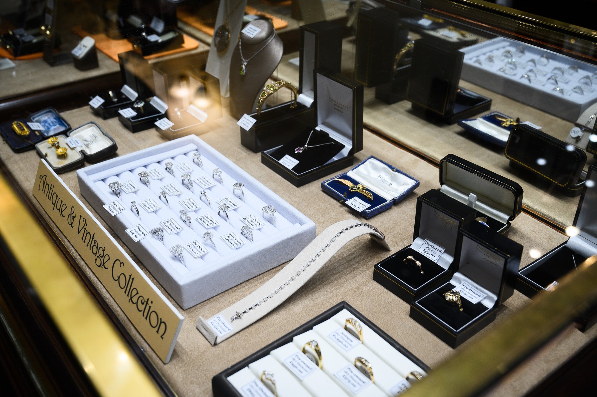 Jewellery display of antique rings, bracelets, brooches and necklaces in a display cabinet