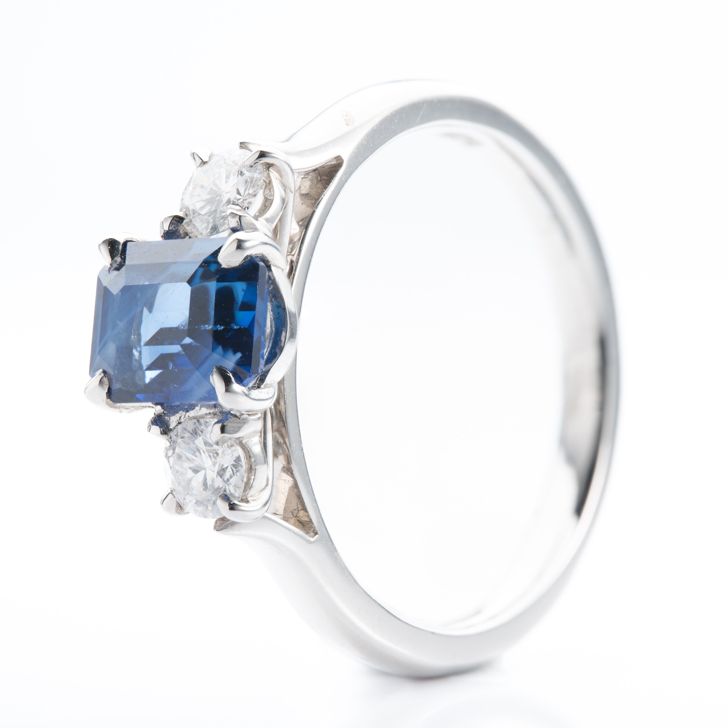 Platinum Emerald cut Sapphire and Brilliant Cut Diamond Trilogy Ring