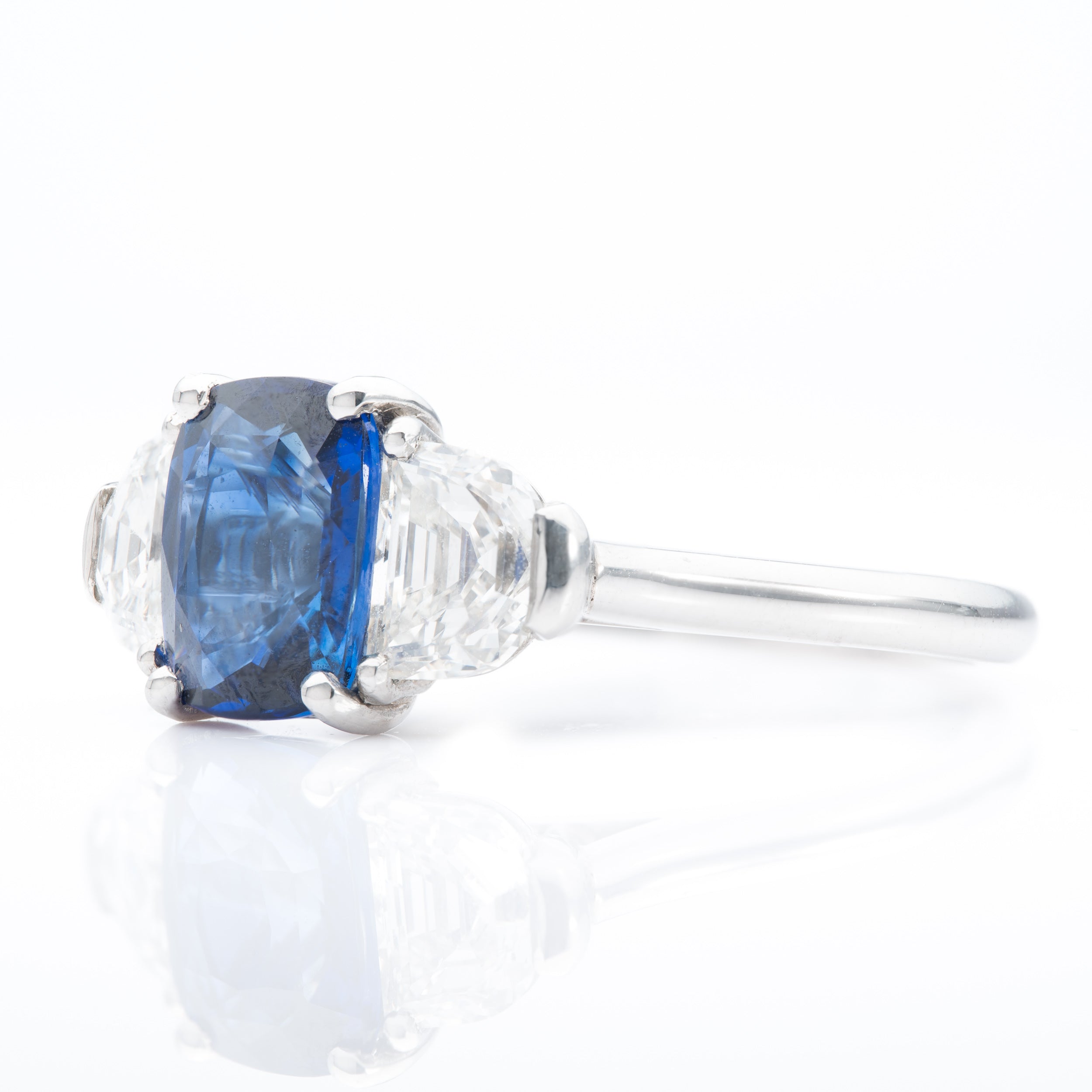 Platinum Cushion Cut Sapphire and Trapeze Cut Diamond Trilogy Ring