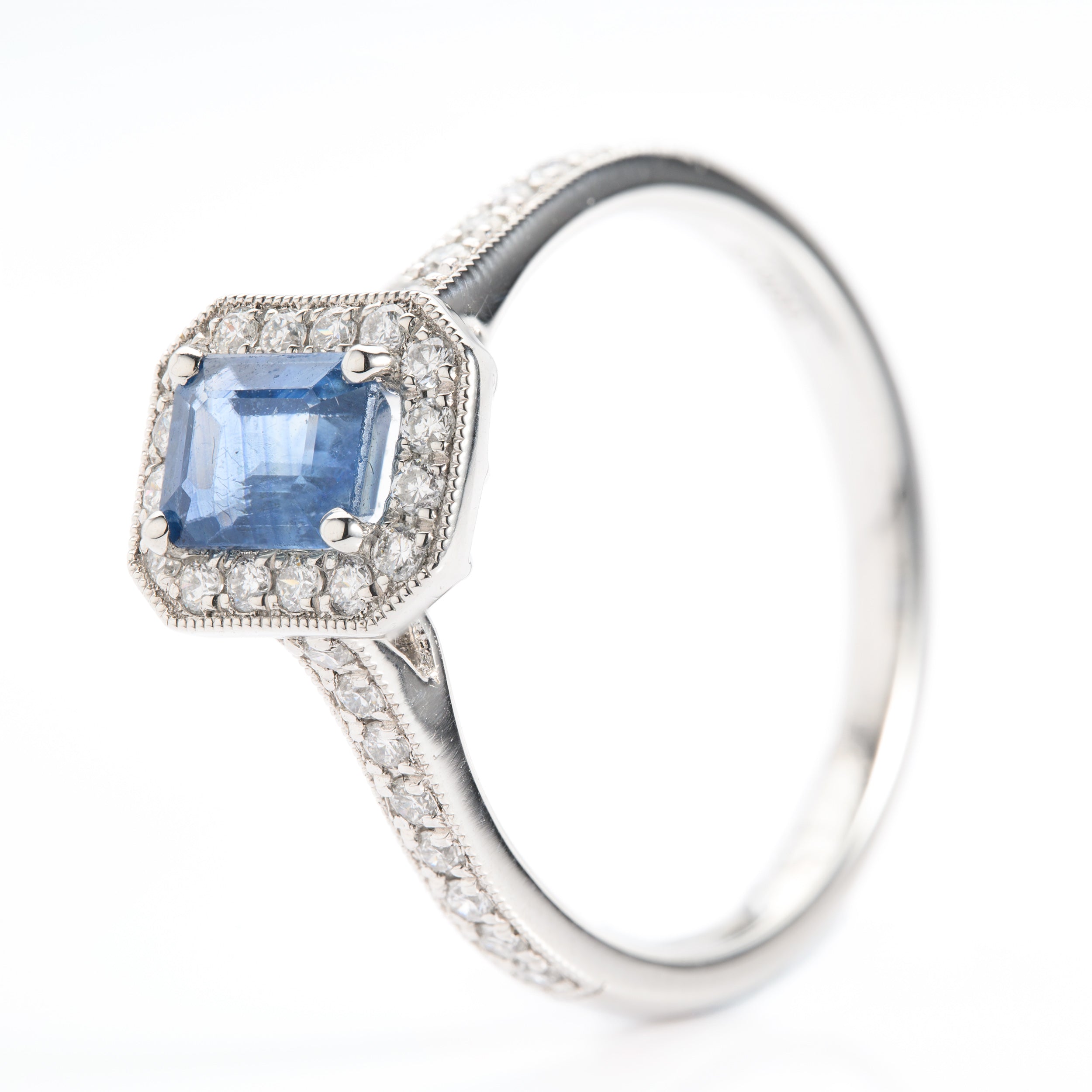 Platinum Emerald Cut Sapphire and Round Brilliant Cut Diamond Halo Cluster Ring