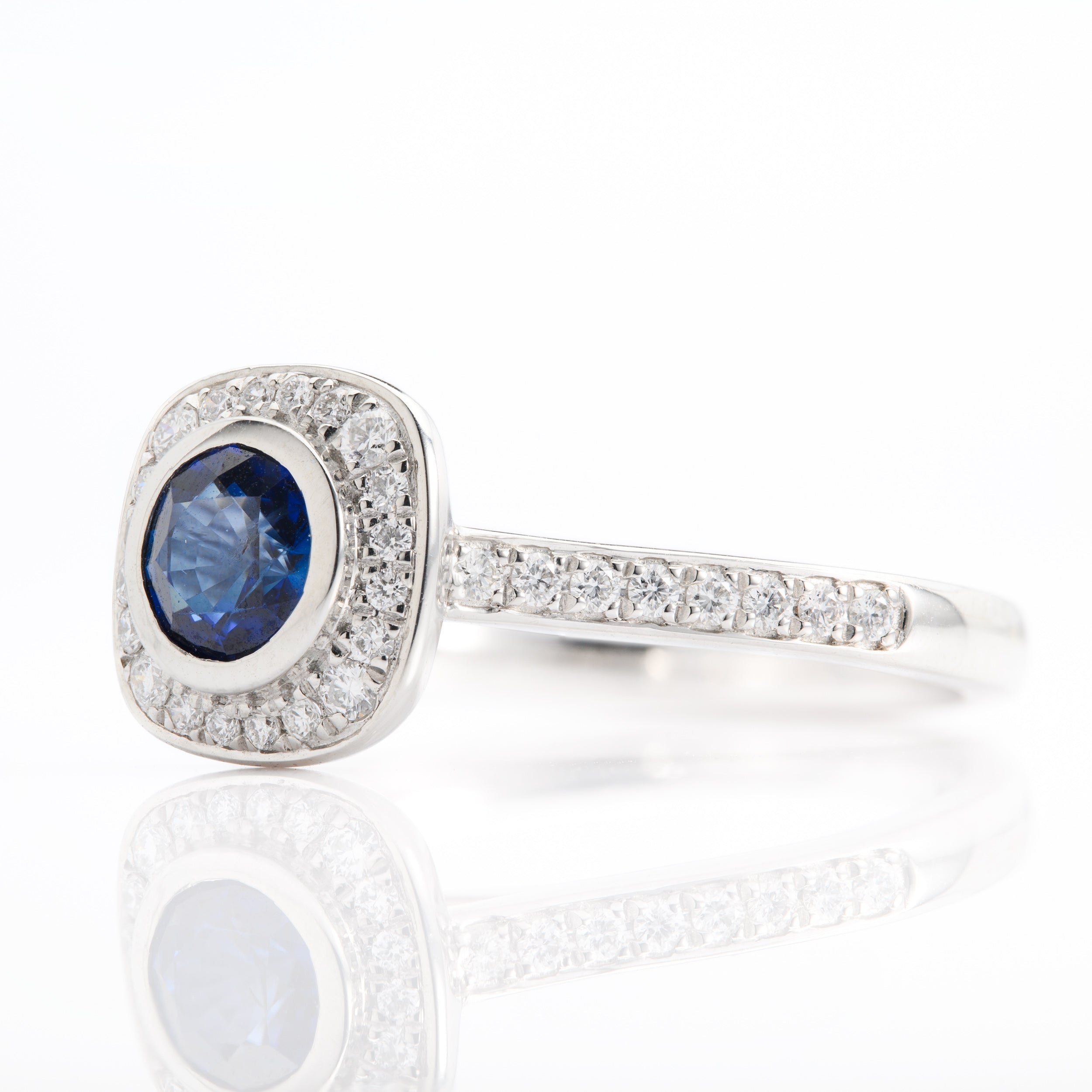 Platinum Round Cut Sapphire and Round Brilliant Cut Diamond Halo Ring