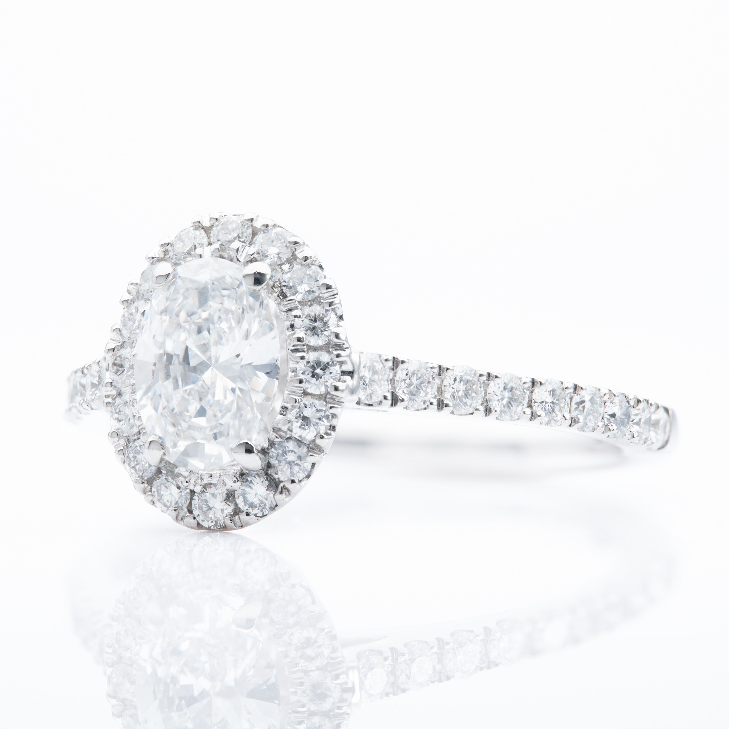 Platinum Oval and Brilliant Cut Diamond Halo Cluster Ring