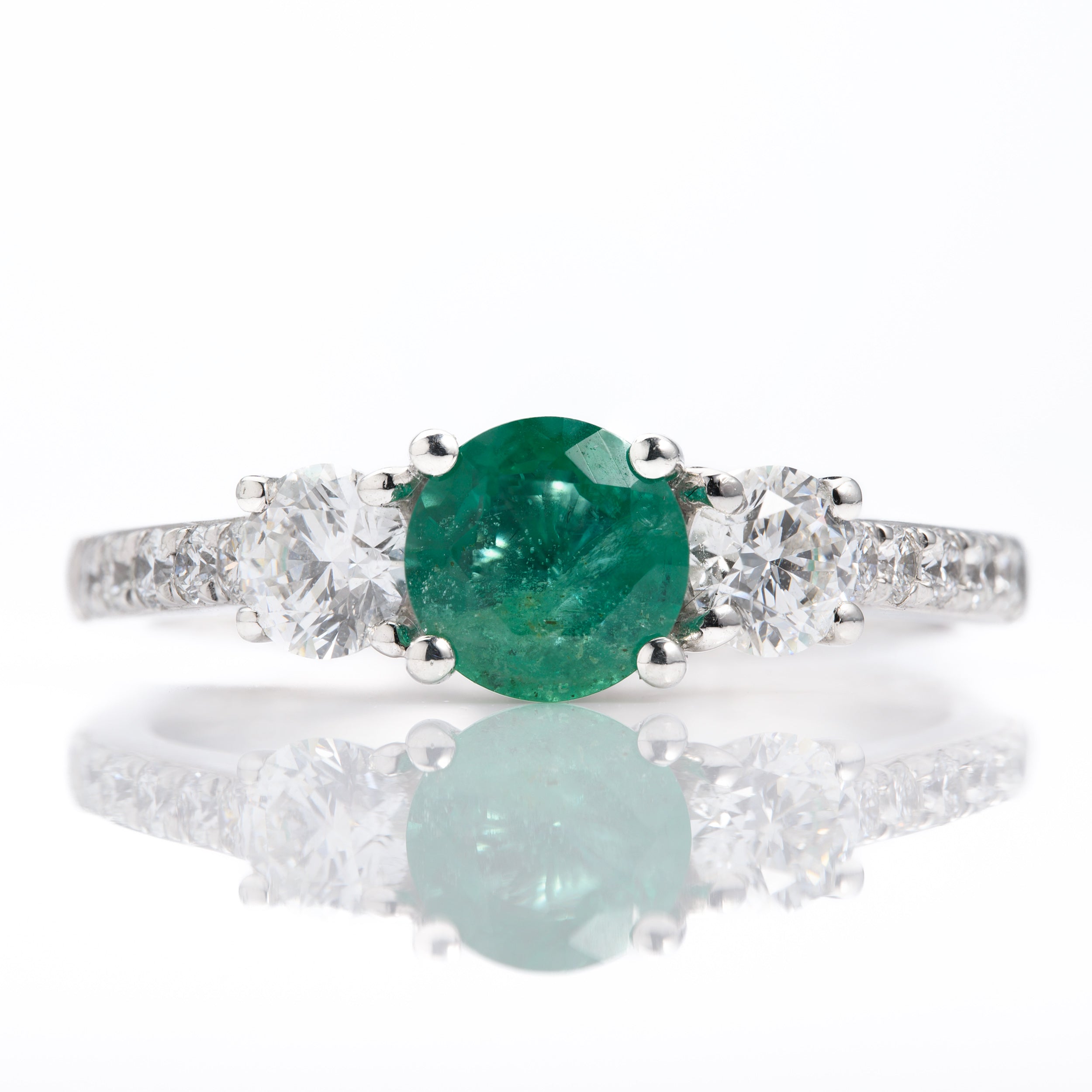 Platinum Round Cut Emerald & Round Brilliant Cut Diamond Trilogy Ring with Diamond Shoulders