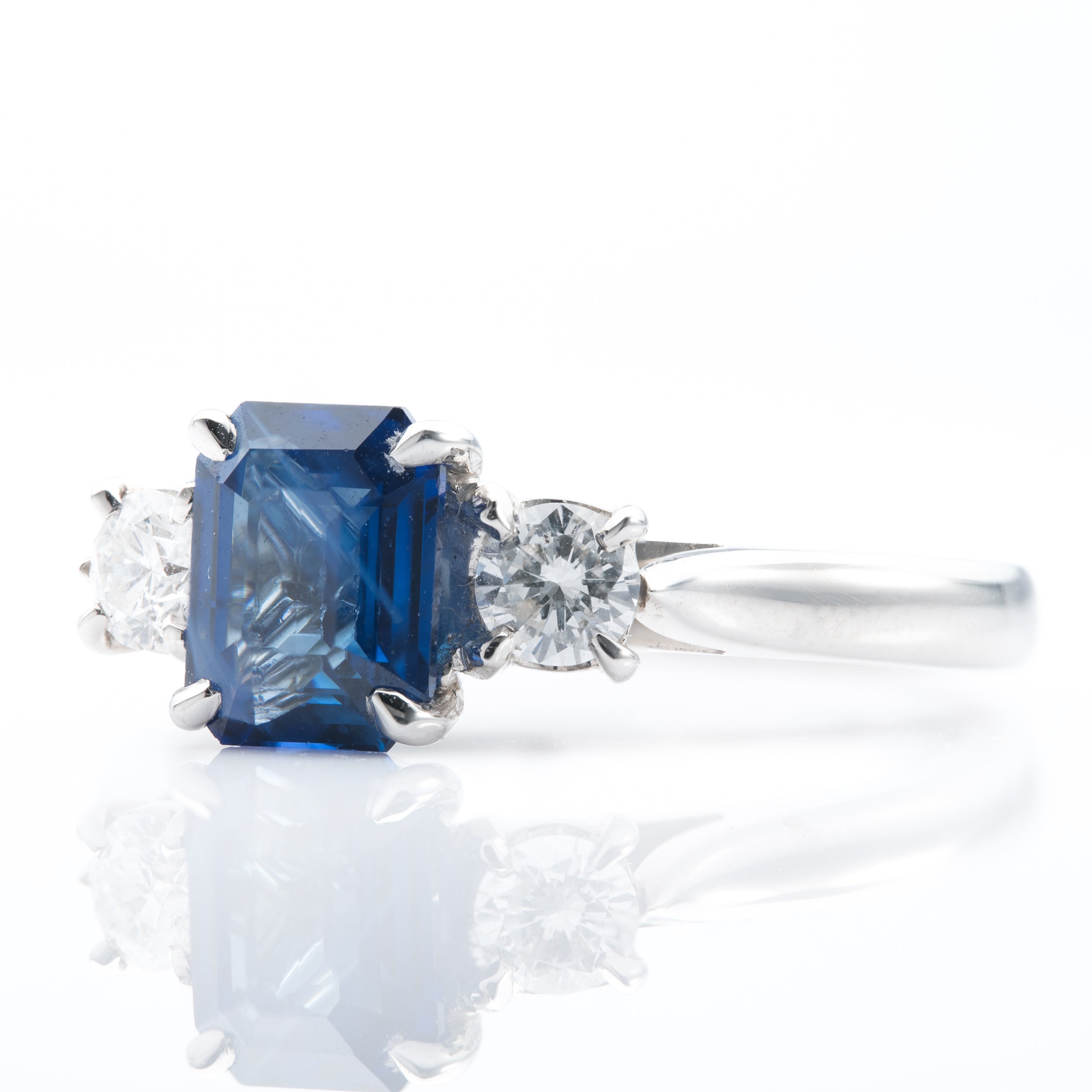Platinum Emerald cut Sapphire and Brilliant Cut Diamond Trilogy Ring