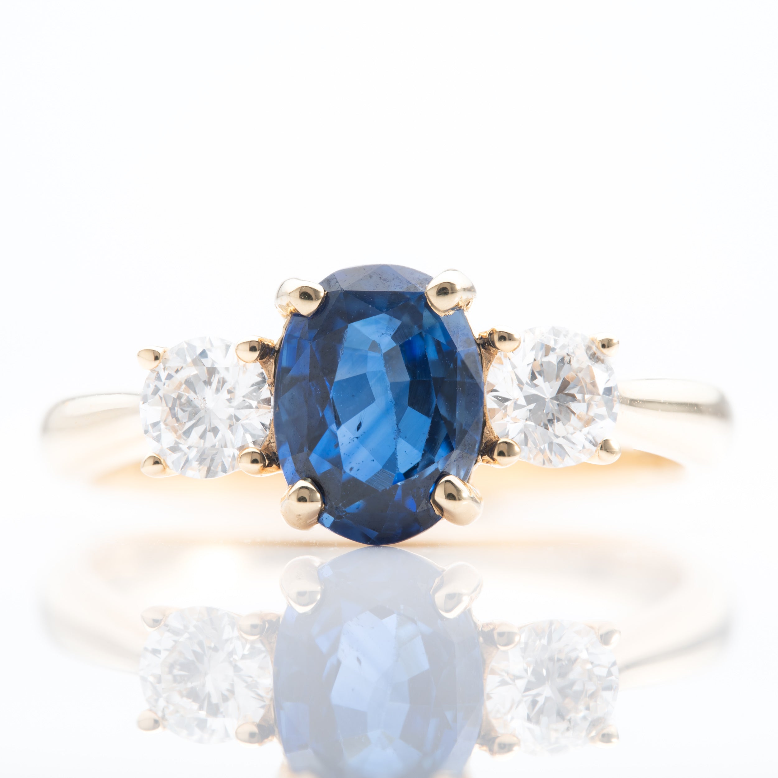 18ct Yellow Gold Oval Cut Sapphire and Brilliant Cut Diamond Trilogy Ring