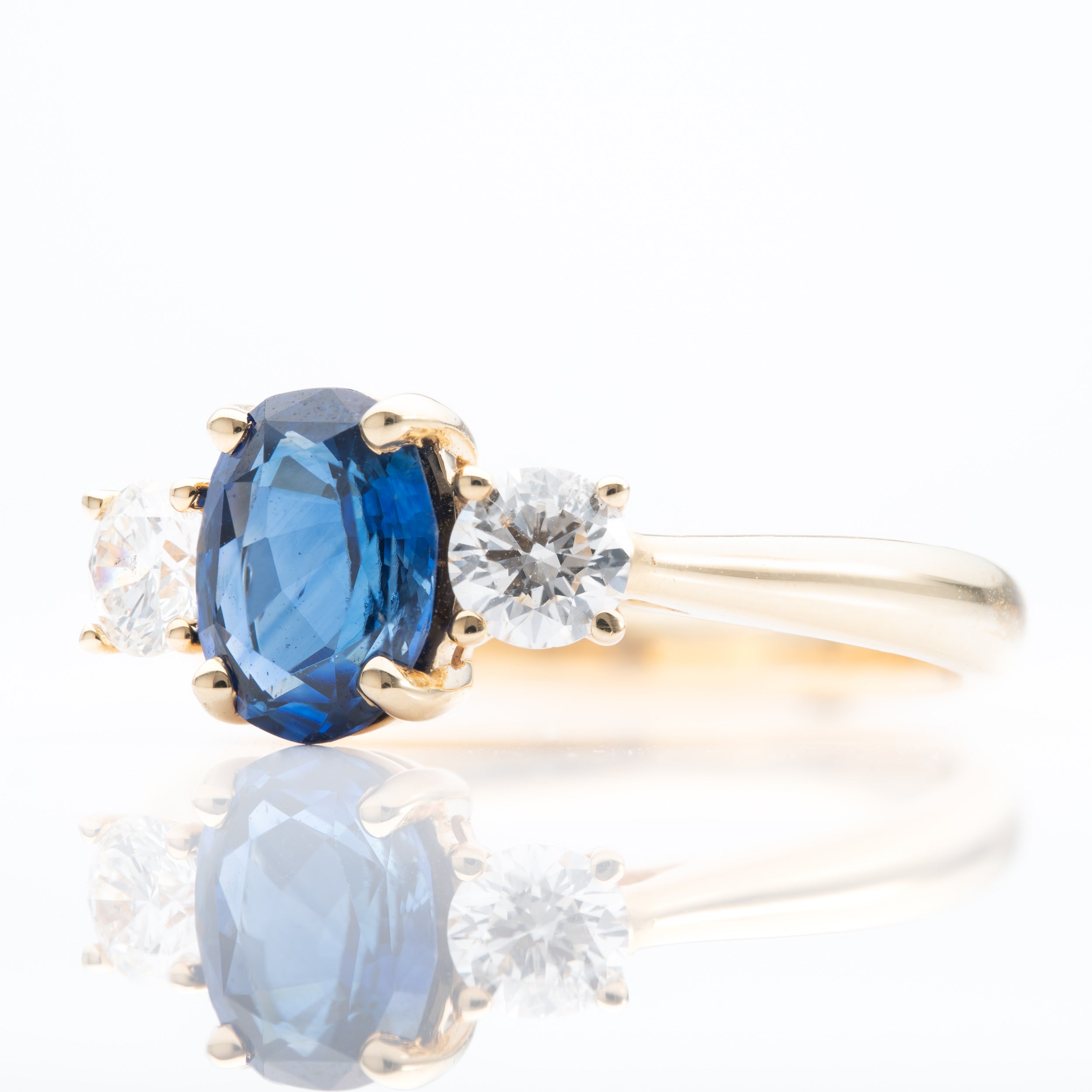 18ct Yellow Gold Oval Cut Sapphire and Brilliant Cut Diamond Trilogy Ring