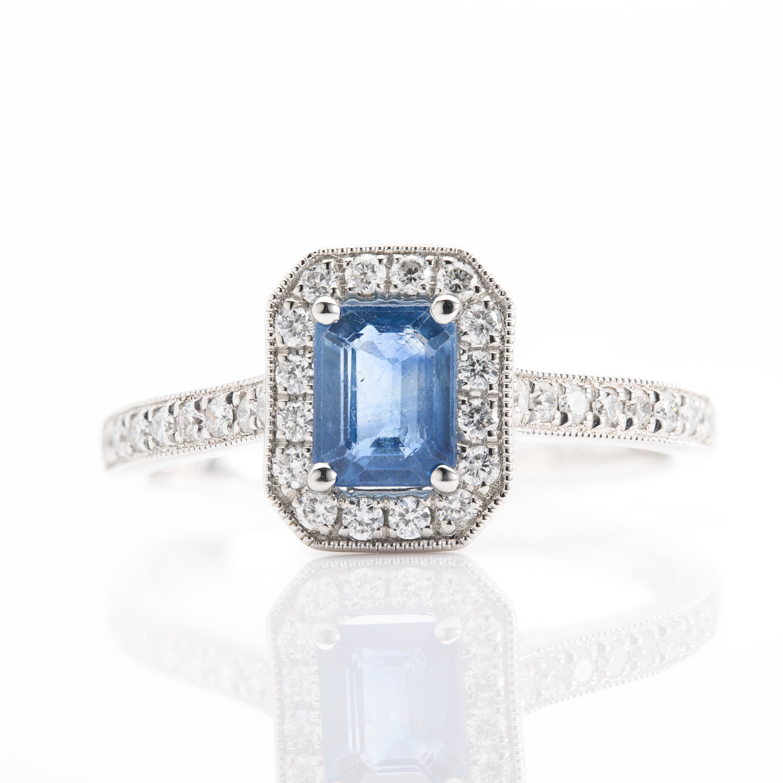 Platinum Emerald Cut Sapphire and Round Brilliant Cut Diamond Halo Cluster Ring