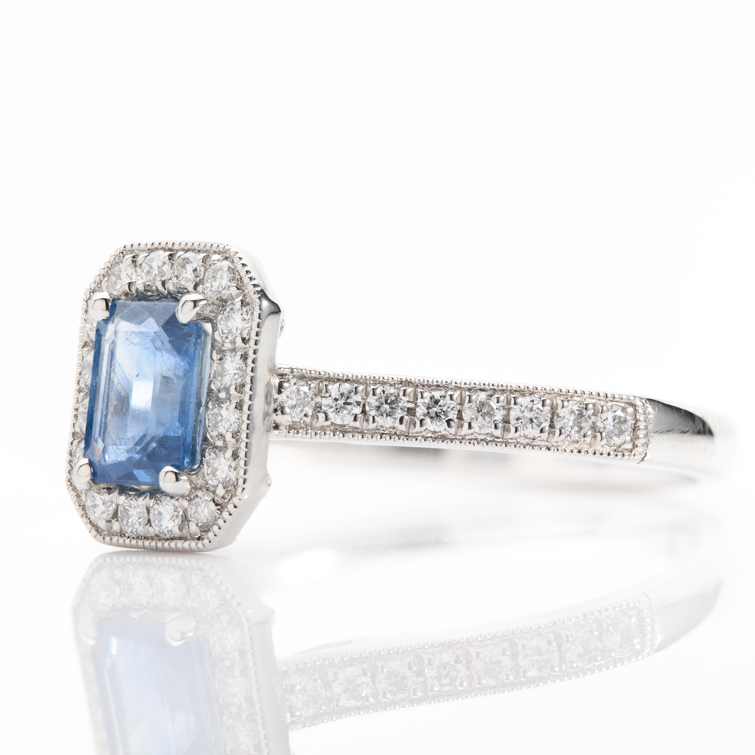Platinum Emerald Cut Sapphire and Round Brilliant Cut Diamond Halo Cluster Ring