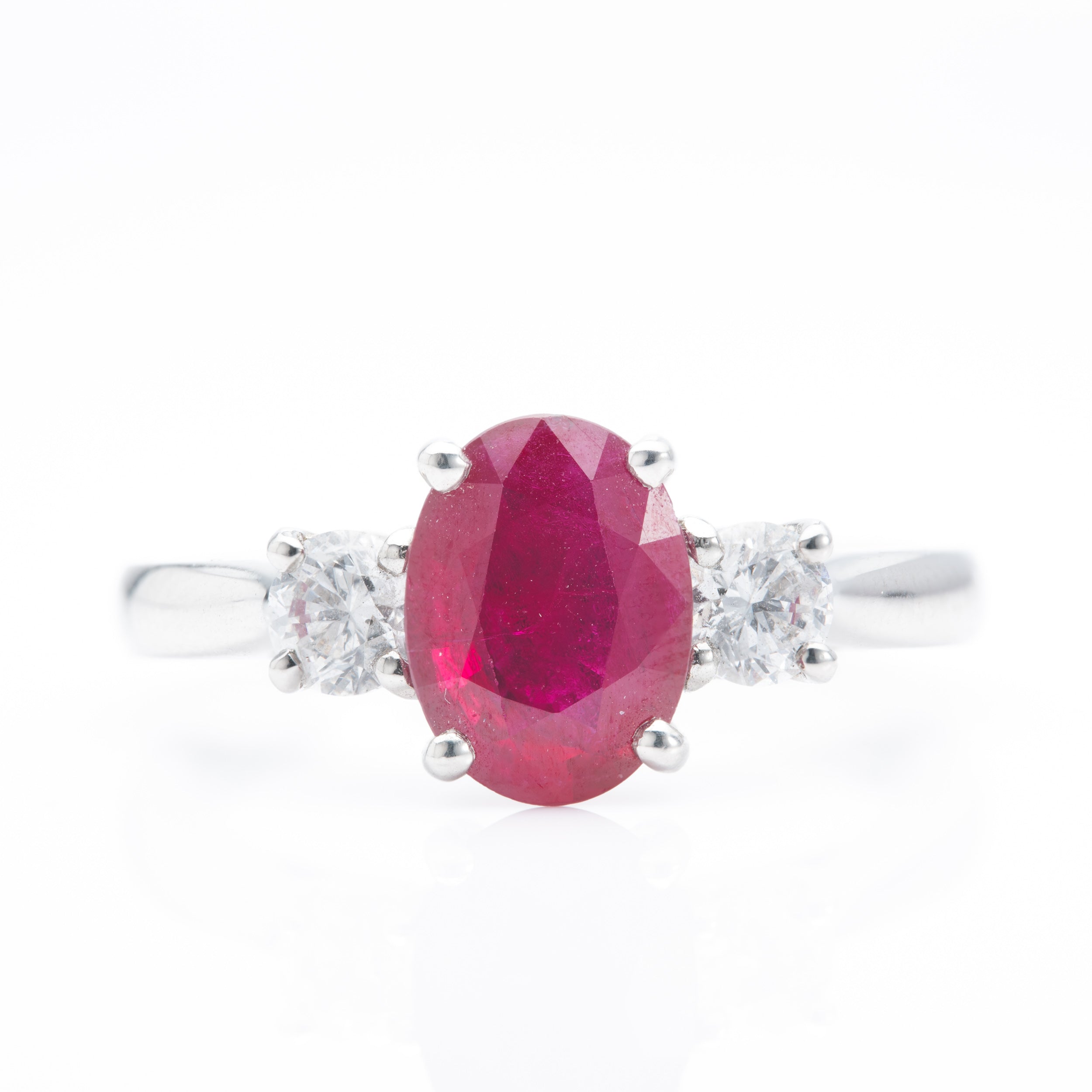 Platinum Oval Cut Ruby and Round Brilliant Cut Diamond Trilogy Ring