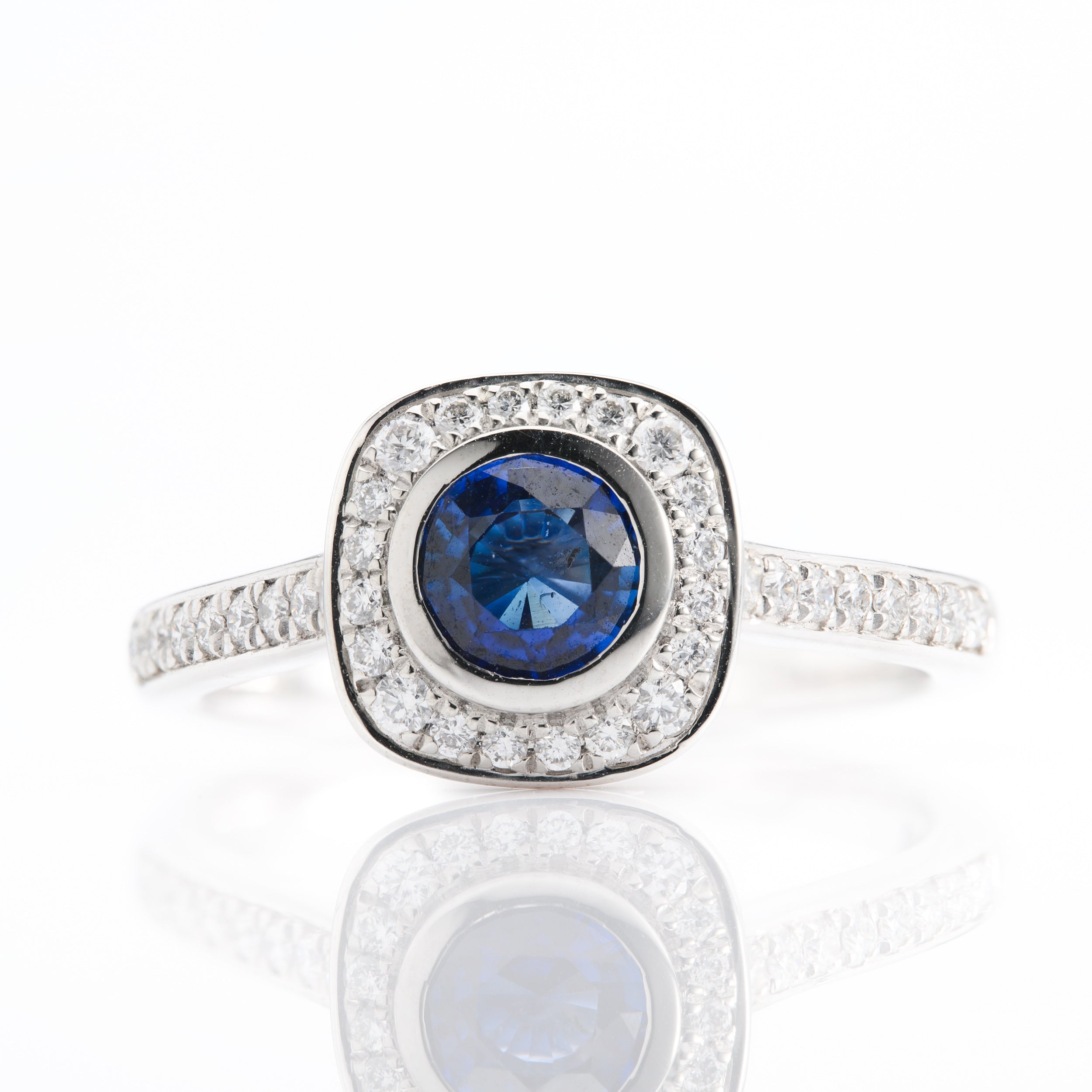 Platinum Round Cut Sapphire and Round Brilliant Cut Diamond Halo Ring