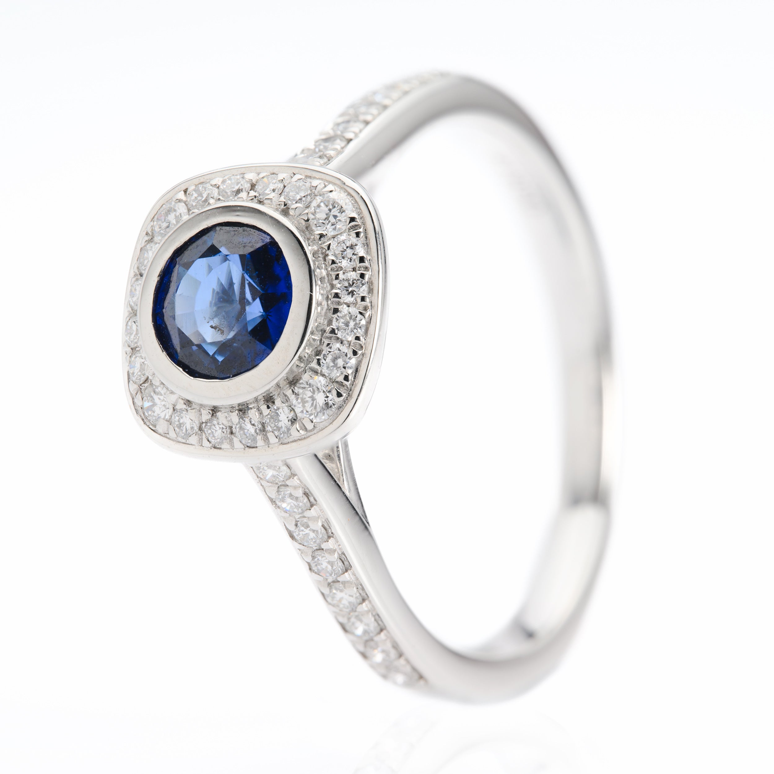 Platinum Round Cut Sapphire and Round Brilliant Cut Diamond Halo Ring