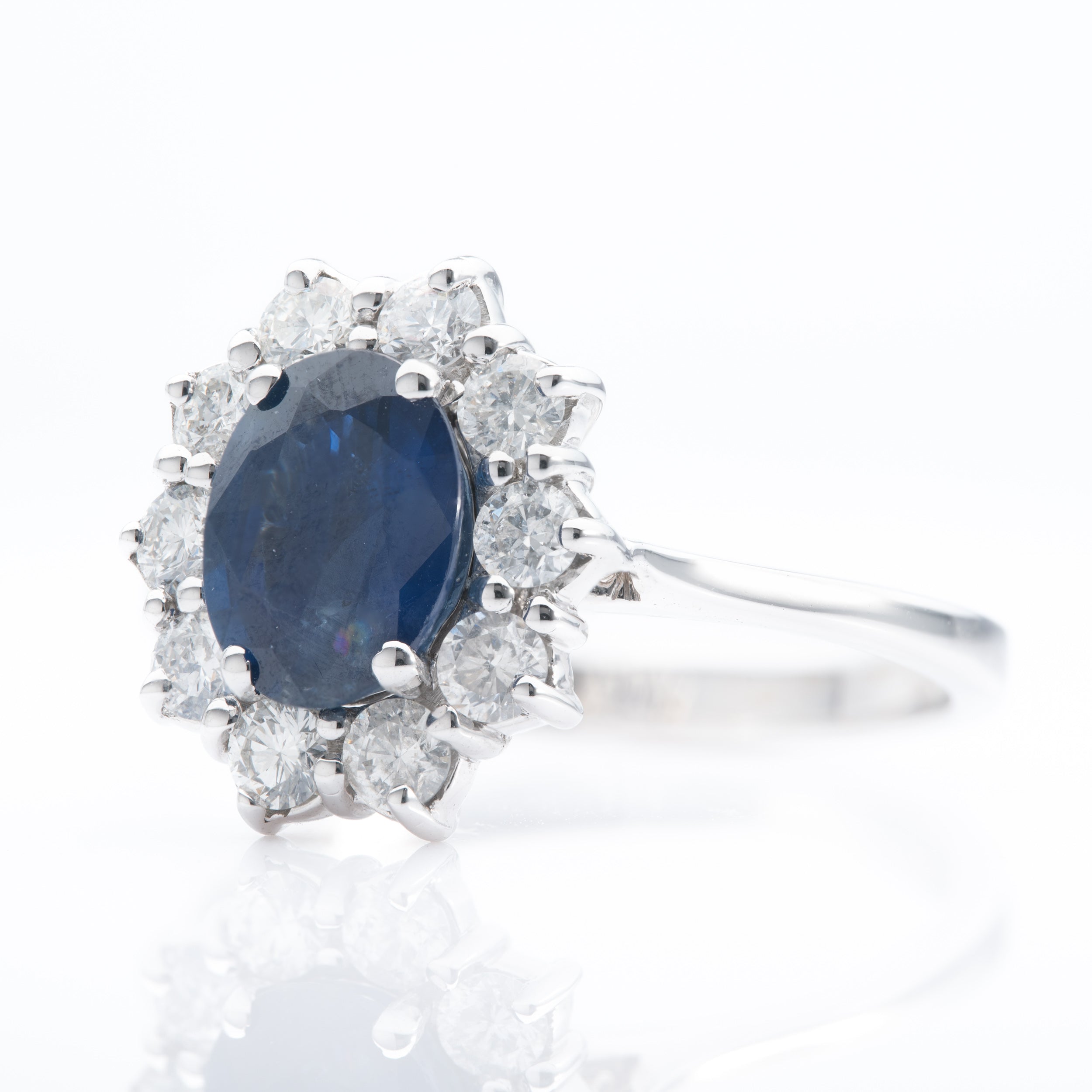 18ct White Gold Oval Cut Sapphire & Brilliant Cut Diamond Cluster Ring