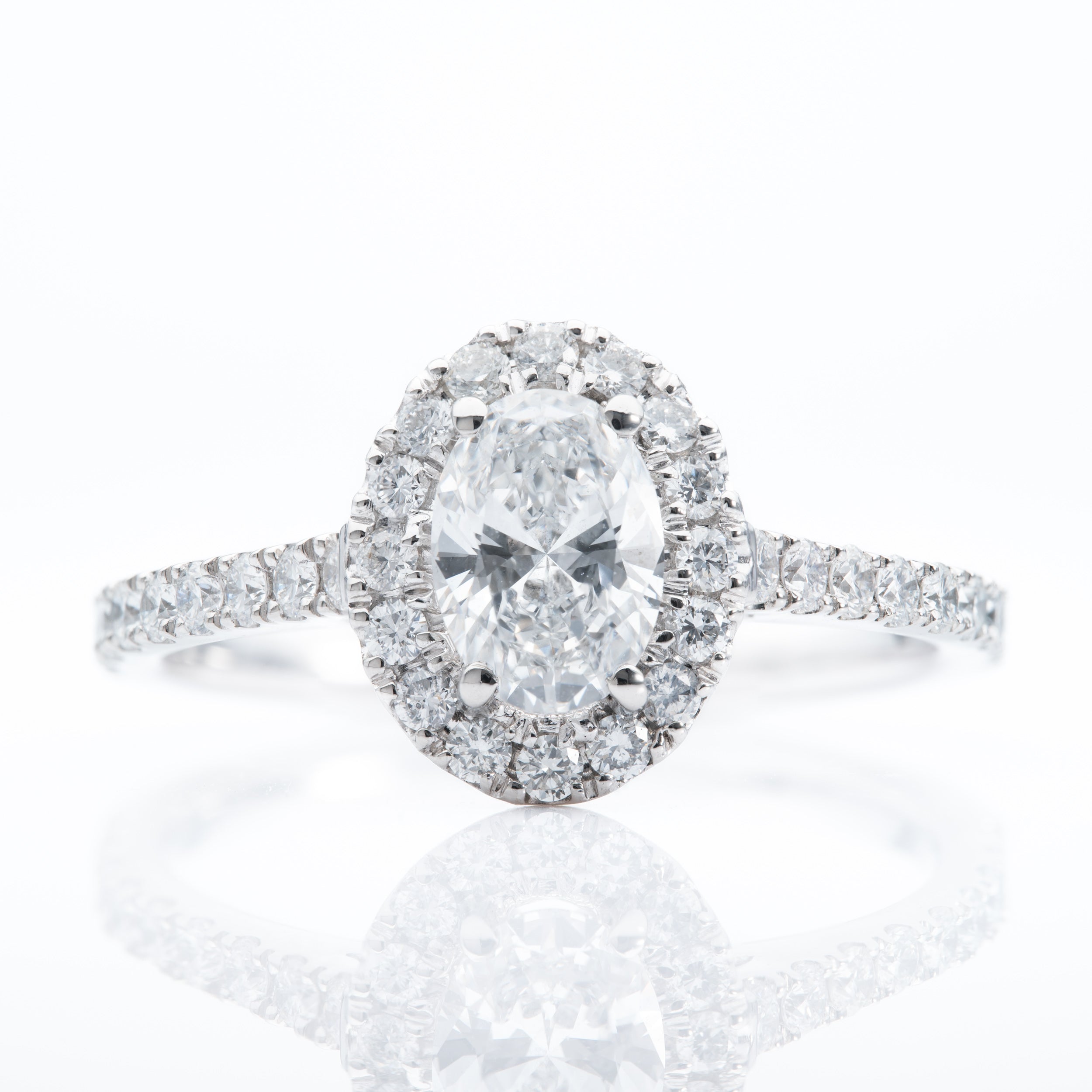 Platinum Oval and Brilliant Cut Diamond Halo Cluster Ring